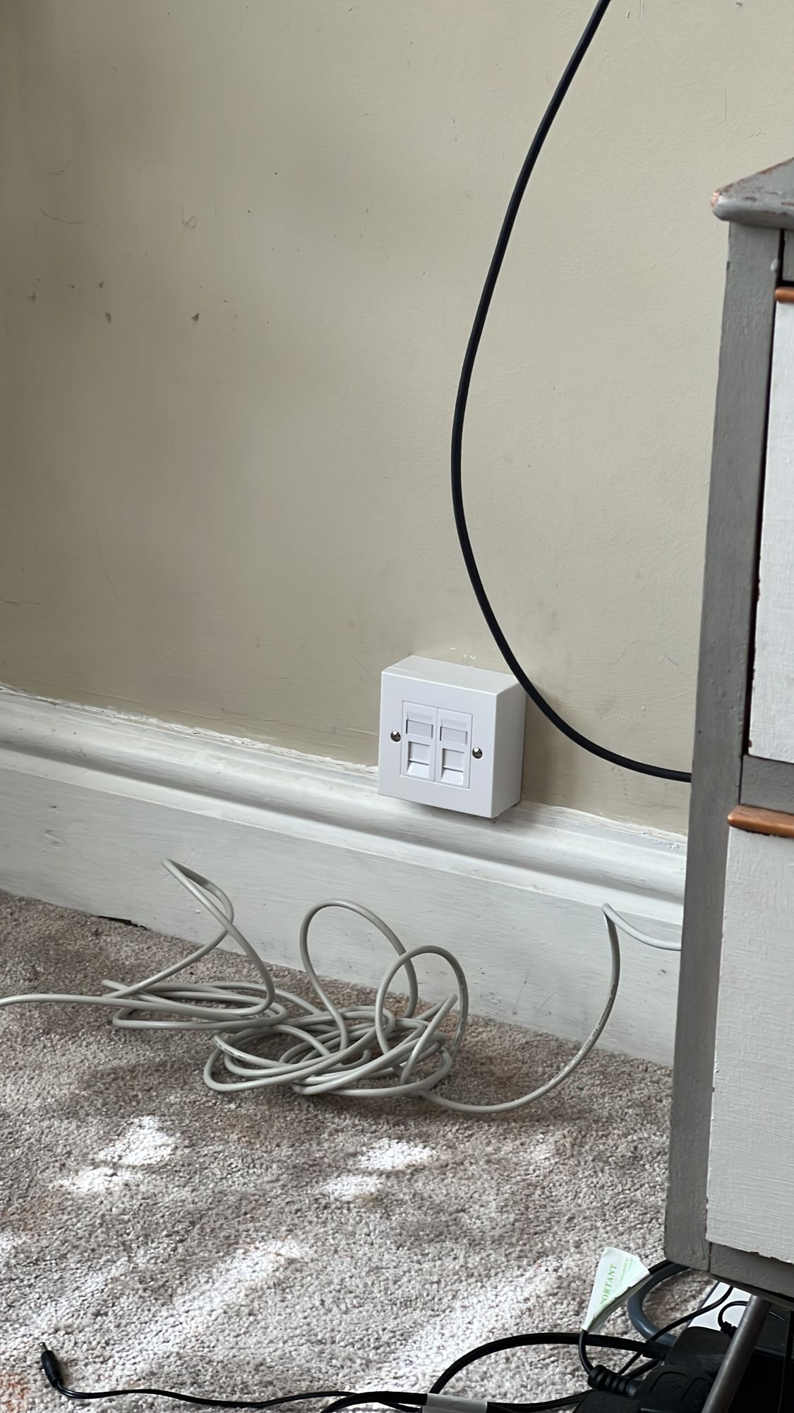 A terminated double RJ45 wall socket fitted neatly above the skirting board